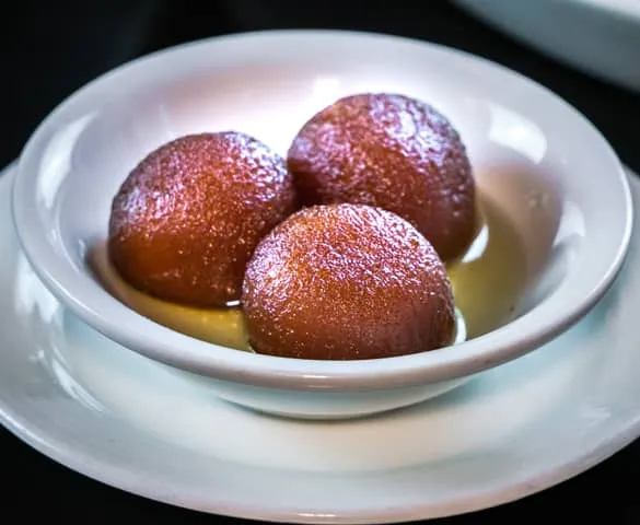 Warm gulab jamun desi dessert in sugar syrup at Foodies Calgary in NE Calgary, AB